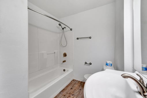 a bathroom with a tub and a sink
