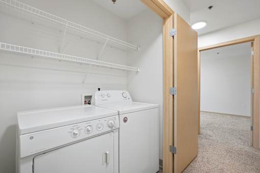A white washer and dryer in a laundry room.