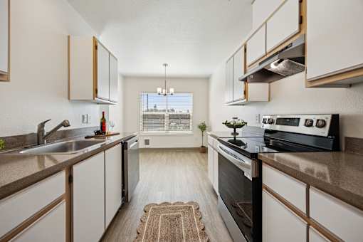A modern kitchen with a black oven and wooden cabinets.