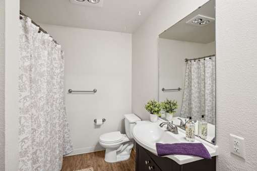 A white toilet sits next to a sink in a bathroom.