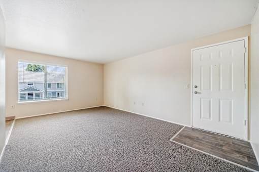 Empty room with a door and a window.