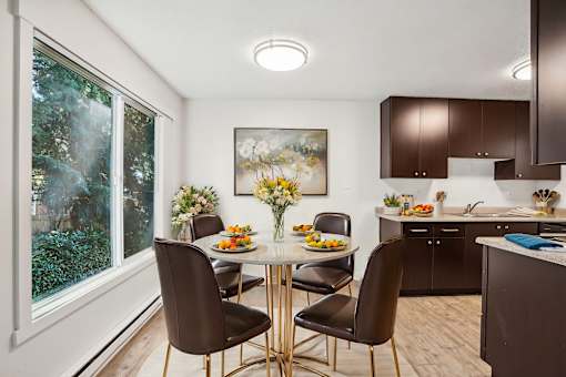 A dining room with a table set for four.