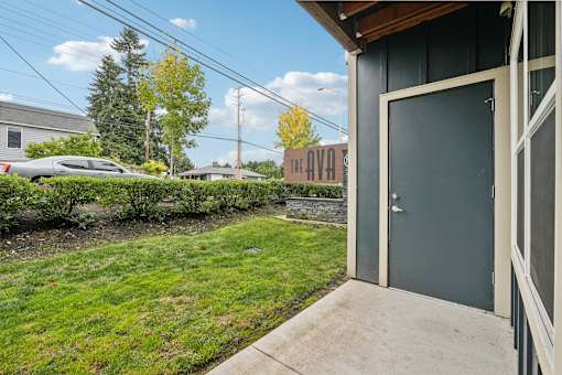 A grey door with a glass window is on the right side of the image.