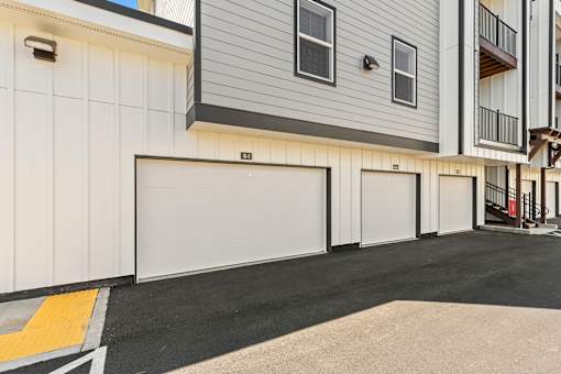 A row of garage doors in front of a building.