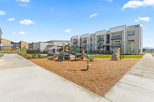 A playground area in front of apartment buildings.