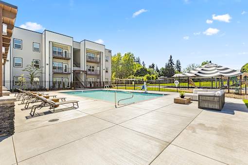A swimming pool in a courtyard surrounded by apartment buildings.