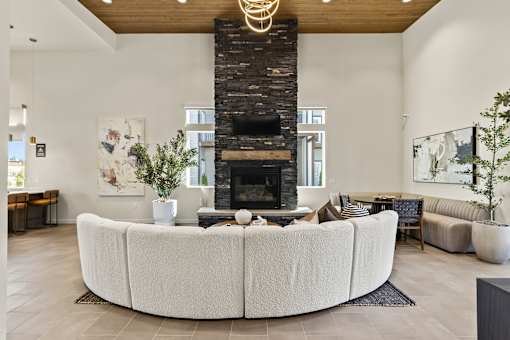 A living room with a fireplace and a large white couch.