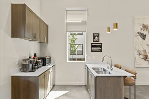 A kitchen with a sink, a window, and a chair.
