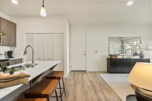 A modern kitchen with wooden floors and a large island.
