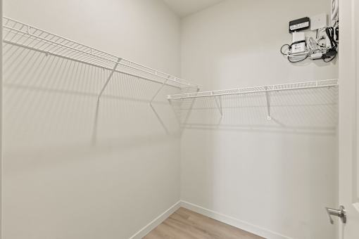 A white closet with a door on the right side.