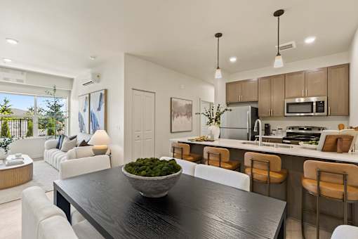 A modern kitchen with a dining table and chairs.