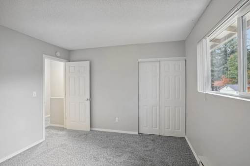 A room with two doors and a window.