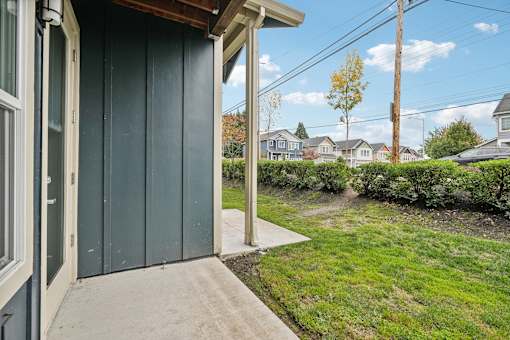 A green wooden garage door with a white door handle.