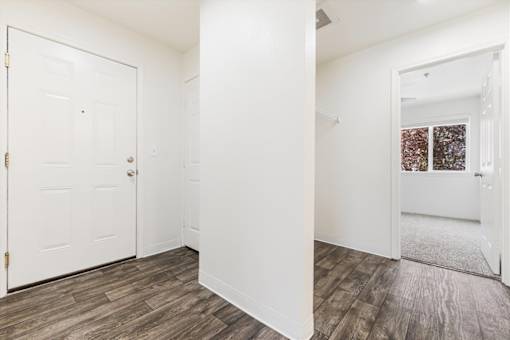 A white door with a gold handle is on the left side of the image.