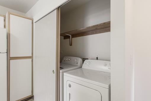A white washer and dryer in a small laundry room.