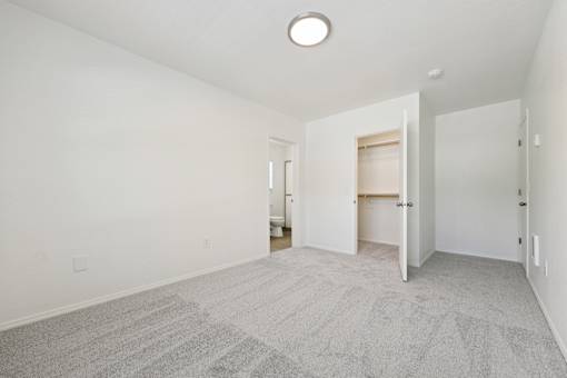 A room with a carpeted floor and a ceiling light.