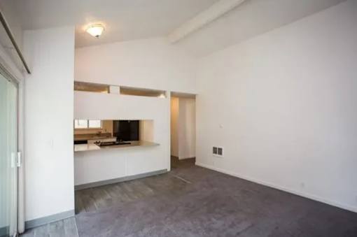 A room with a grey floor and white walls.