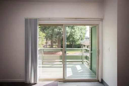 A view of a backyard through a sliding glass door.