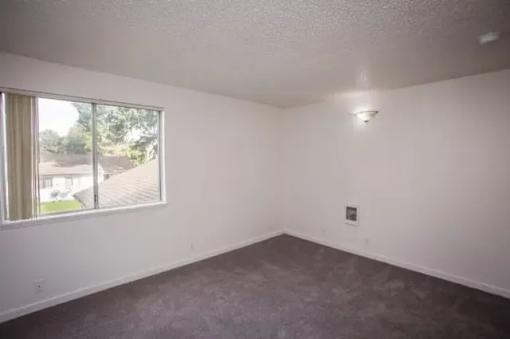 A room with a window and a ceiling light.