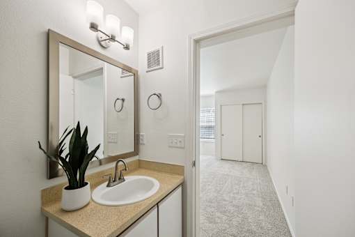 A bathroom with a sink and mirror.