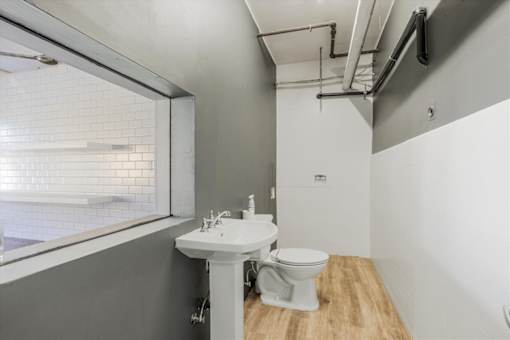 A white sink and toilet in a small bathroom.
