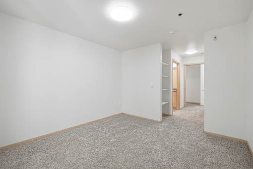 A room with a carpeted floor and white walls.