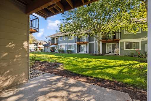 A view of a residential area with houses and green lawns.