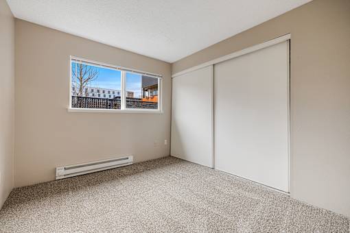 A room with a window and a closed door.
