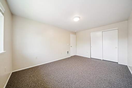 A room with a carpeted floor and a white ceiling.