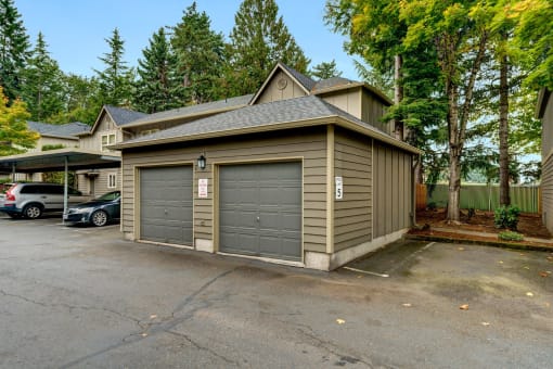 a garage with two doors and a parking lot