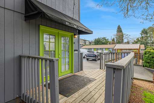 A building with a green door and a sign that says "Welcome Center".