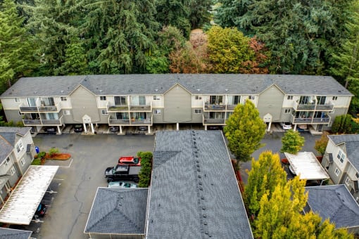 an aerial view of an apartment building with a parking lot