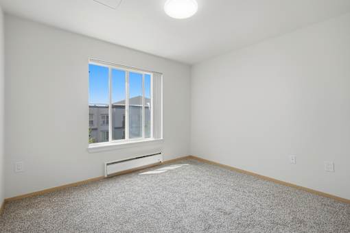 A room with a window and a bench.
