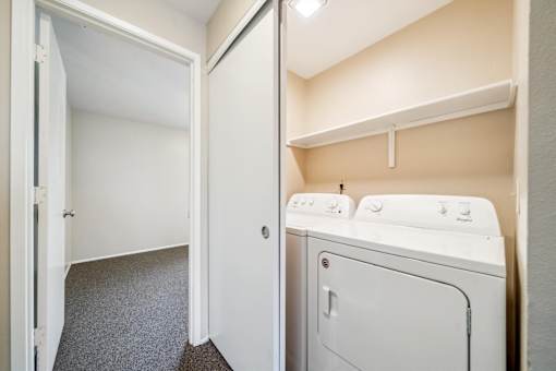 A small laundry room with a washer and dryer.