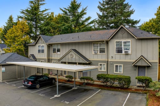 a car parked in a parking lot in front of a house