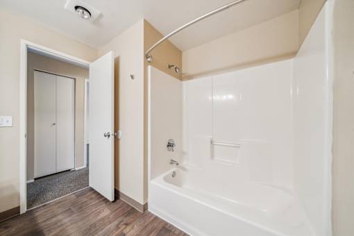 A white bathroom with a tub and a walk-in shower.