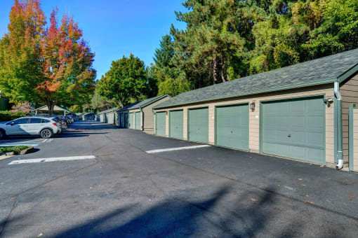 a row of garages with cars parked in front of them
