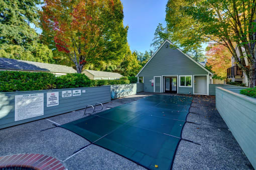 a backyard with a tennis court and a house
