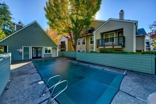 a backyard with a tennis court and a house