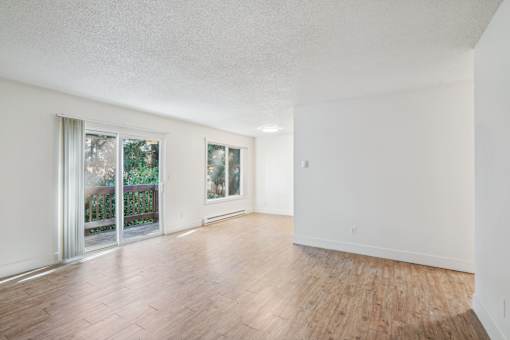 A room with wooden floors and white walls.