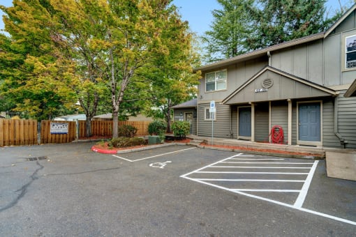 an empty parking lot in front of an apartment building