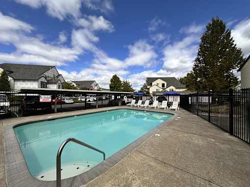 A small pool with a metal ladder in the middle of it.