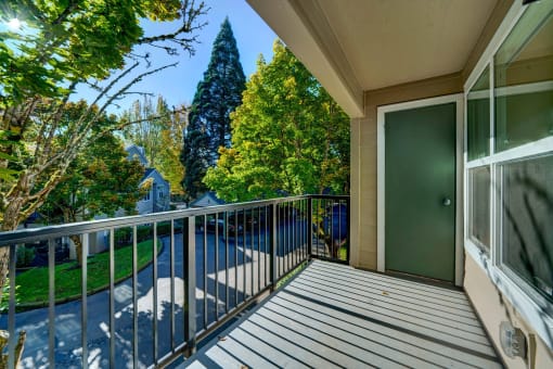 the view from the balcony of a home with a balcony railings and a door