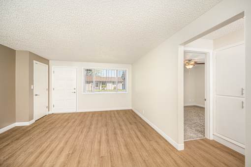 A room with wooden floors and white walls.