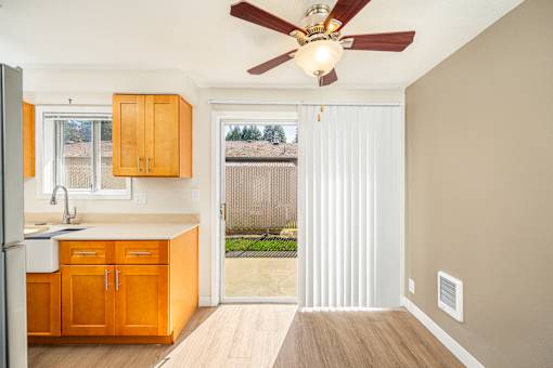 A kitchen with wooden cabinets and a white fridge.