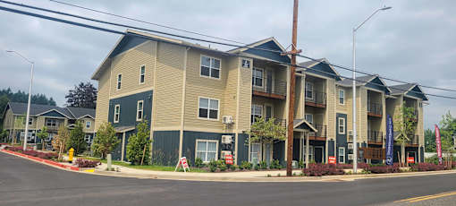 Apartment building with a grey and tan exterior.