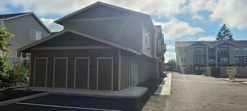 A parking lot with a building in the background.