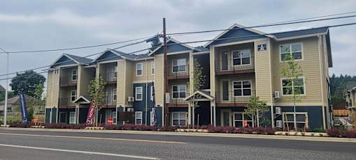 Apartment building with multiple balconies and doors.