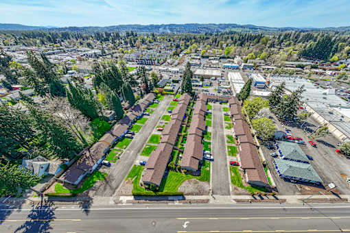 A large aerial view of a residential area with houses and a parking lot.