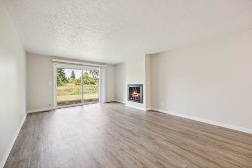 A room with a fireplace and sliding glass doors.